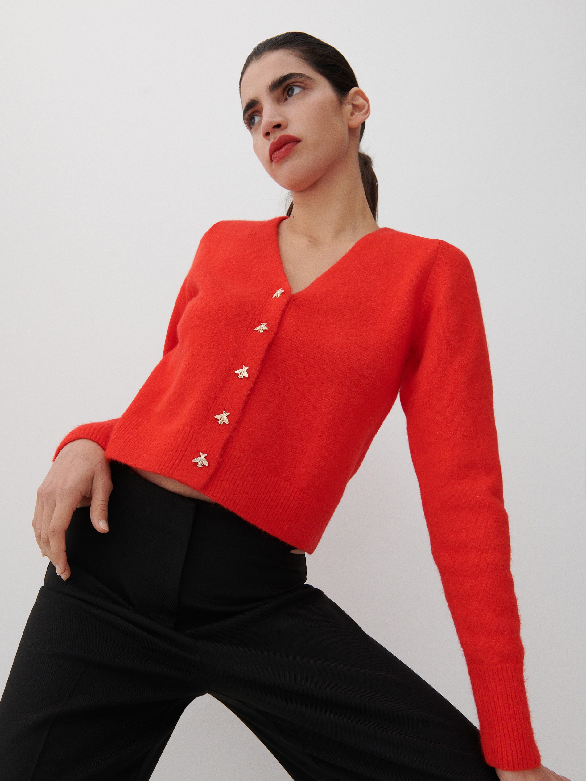 Reserved Red/Orange Short cardigan with v neck, long sleeves, and gold bee buttons to fasten it. 